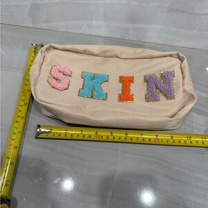 Beige Pouch with Colorful Lettering